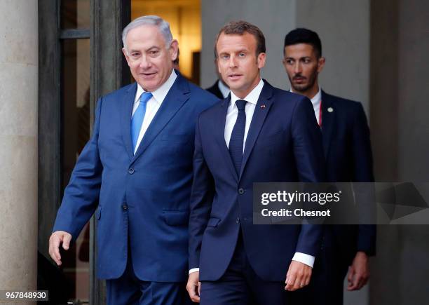 French President Emmanuel Macron accompanies Israeli Prime Minister Benjamin Netanyahu after their meeting at the Elysee Presidential Palace on June...