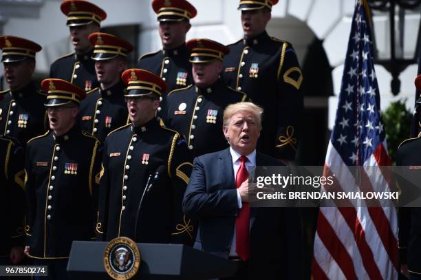 President Donald Trump sings the National Anthem in the "Celebration of America" at the White House in Washington, DC, on June 5, 2018. - Trump's...