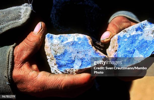 Worker holds a Lapis Lazuli stone in his hands in the Flores de Los Andes mine, located at 3,700 meter high in the Andes, on April 1 near Ovalle,...