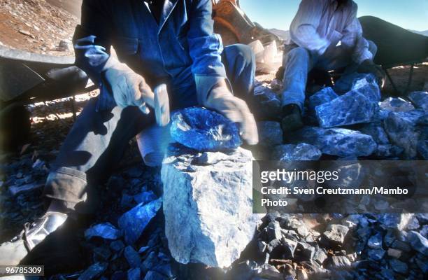 Workers hammer Lapis Lazuli in the Flores de Los Andes mine, located at 3,700 meter high in the Andes, on April 1 near Ovalle, Northern Chile. The...