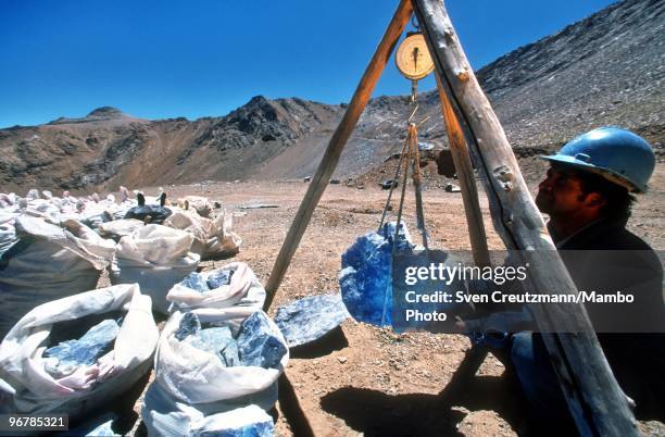 Worker weighs a block of the precious Lapis Lazuli stone, in the Flores de Los Andes mine, located at 3,700 meter high in the Andes, on April 1 near...