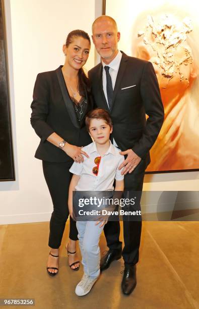 Jean-David Malat poses with wife Iriane Malat and son Joshua Malat at the Grand Opening of JD Malat Gallery in Mayfair on June 5, 2018 in London,...