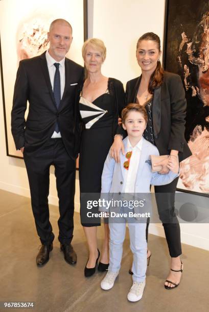 Jean-David Malat poses with his mother Anne Malat, wife Iriane Malat and son Joshua Malat at the Grand Opening of JD Malat Gallery in Mayfair on June...