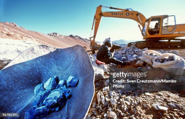 Worker prepares Lapis Lazuli to put them in a wheelbarrow, in the Flores de Los Andes mine, located at 3,700 meter high in the Andes, on April 1 near...
