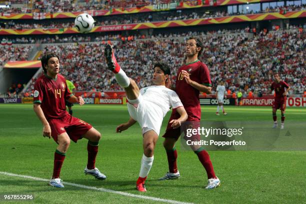 Vahid Hashemian of Iran in action, watched by Nuno Valente and Ricardo Carvalho of Portugal, during the FIFA World Cup Group D match between Portugal...