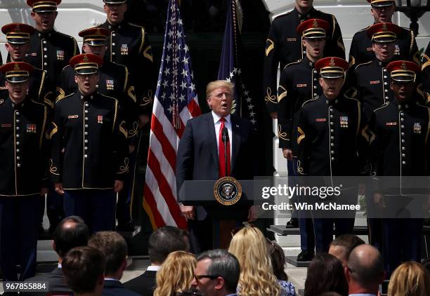 President Donald Trump sings the national anthem with a U.S. Army chorus during a "Celebration of America" event on the south lawn of the White House...