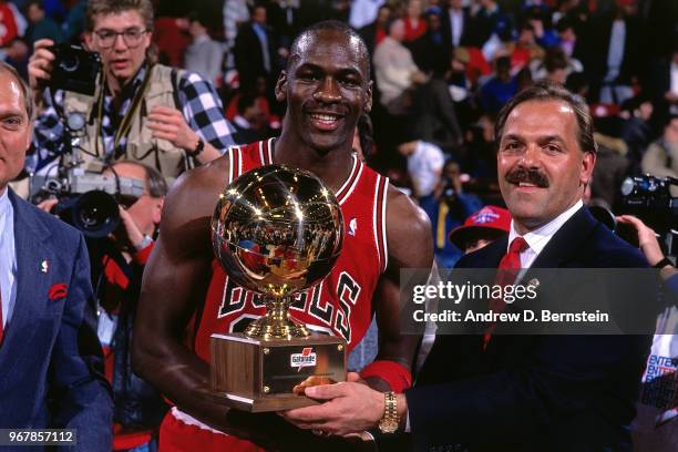 Slam dunk contest winner Michael Jordan of the Chicago Bulls receives trophy during the 1988 Slam Dunk Contest circa 1988 at Chicago Stadium in...