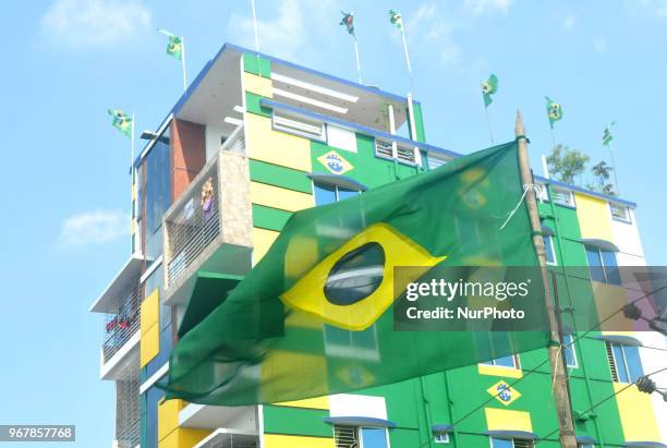 An enthusiast supporter of Brazilian football team decorates his home at Narayanganj of Bangladesh with Brazilian national flag ahead of the World...