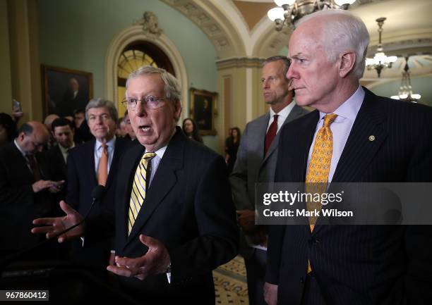 Senate Majority Leader Mitch McConnell speaks as Sen. John Cornyn looks on after attending the Senate Republican policy luncheon on June 5, 2018 in...