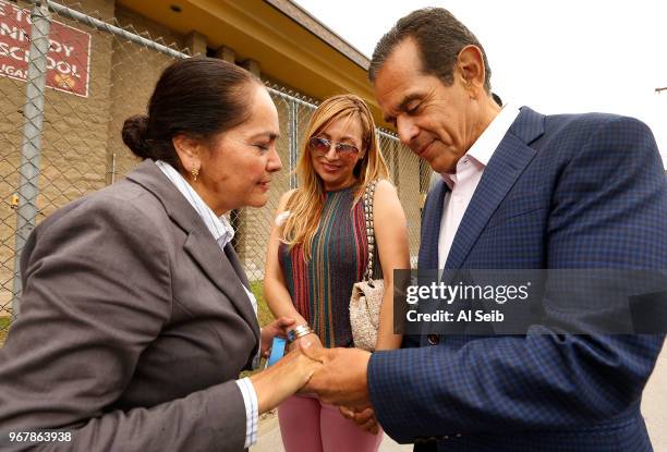 Democratic candidate for governor Antonio Villaraigosa, with wife Patty Villaraigosa at his side, is stopped by Martha Jimenez to hold hands and say...