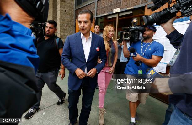 Democratic candidate for governor Antonio Villaraigosa, with wife Patty Villaraigosa at his side, talks to media after submitting his completed mail...