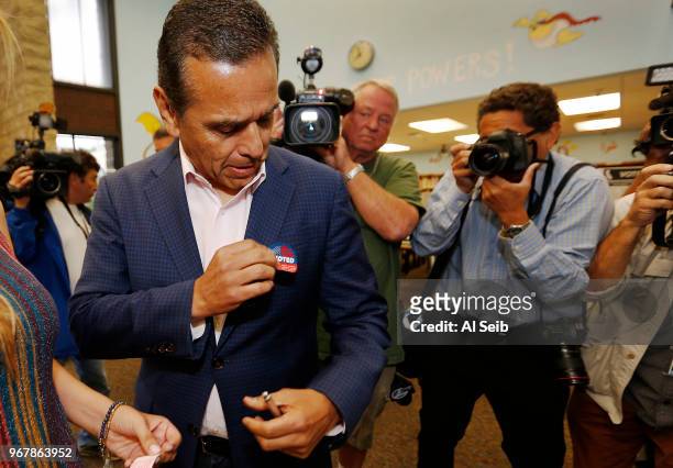 Democratic candidate for governor Antonio Villaraigosa with his wife Patty Villaraigosa dropped of his completed mail ballot Tuesday morning June 5,...