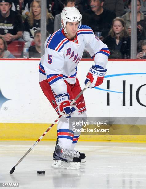 Dan Girardi of the New York Rangers moves the puck against the Pittsburgh Penguins on February 12, 2010 at the Mellon Arena in Pittsburgh,...