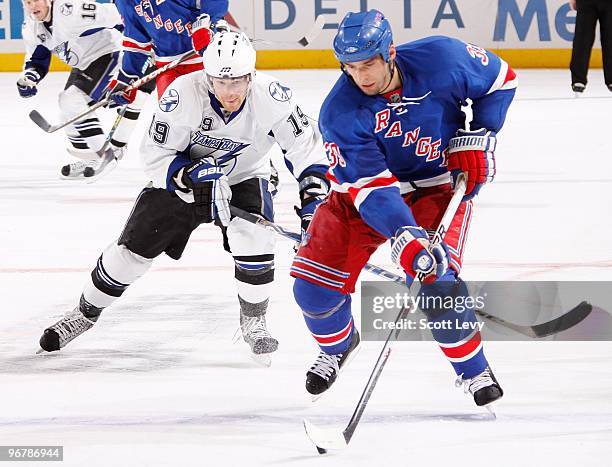 Michal Rozsival of the New York Rangers skates for the puck under pressure by Stephane Veilleux of the Tampa Bay Lightning on February 14, 2010 at...