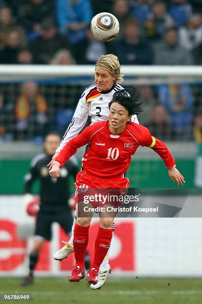 Saskia Bartusiak of Germany and Kim Yong Ae of North Korea go up for a header during the Women's international friendly match between Germany and...