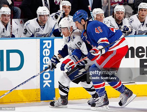 Stephane Veilleux of the Tampa Bay Lightning skates for the puck under pressure by Jody Shelley of the New York Rangers on February 14, 2010 at...