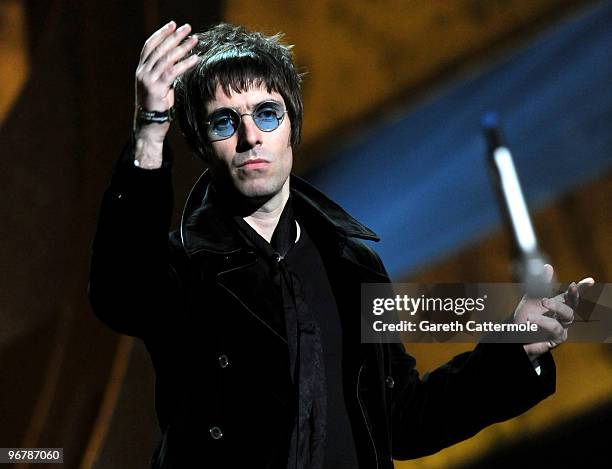 Liam Gallagher throws his microphone into the audience after accepting Oasis' award for 'Best Album of 30 Years' on stage at The Brit Awards 2010 at...