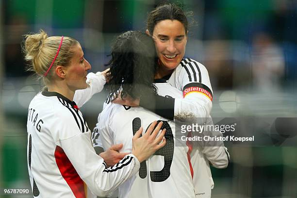 Fatmire Bajramaj of Germany celebrates the first goal with Anja Mittag and Birgit Prinz during the Women's international friendly match between...