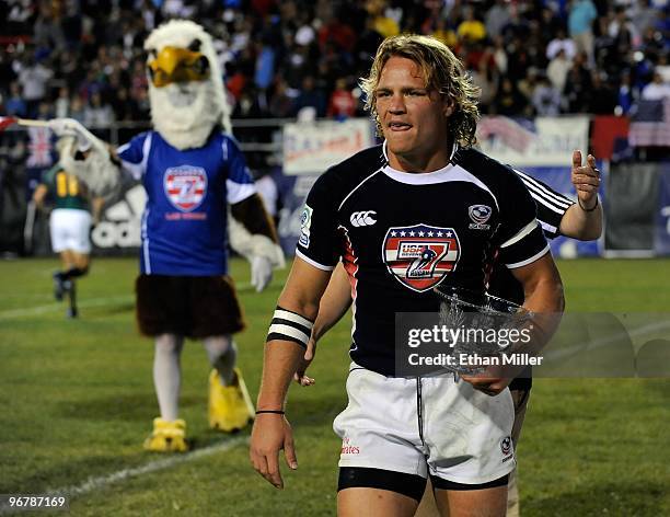 Paul Emerick of the United States carries the trophy after the team's 28-17 victory over France in the Bowl Final match of the IRB Sevens World...