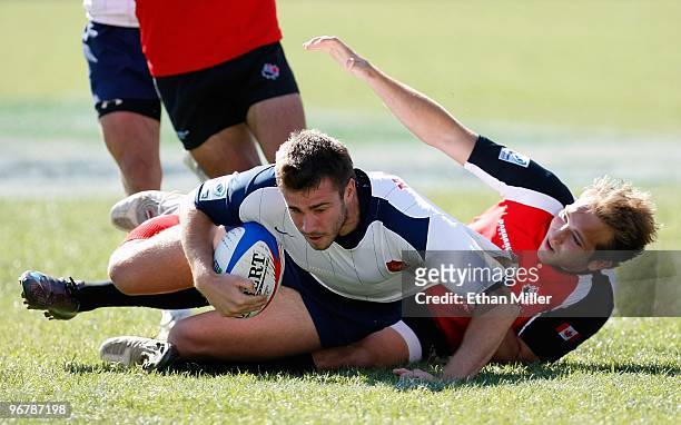 Jeremie Malzieu of France is tackled by Sean White of Canada during the IRB Sevens World Series at Sam Boyd Stadium February 14, 2010 in Las Vegas,...