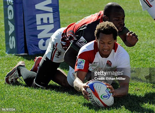 Lavin Asego of Kenya and Dan Norton of England fight for the ball in the try zone during the IRB Sevens World Series at Sam Boyd Stadium February 14,...
