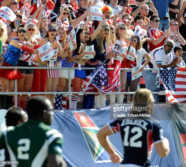 Fans of the United States cheer as the team, including Paul Emerick, takes the pitch for a game against Guyana during the IRB Sevens World Series at...