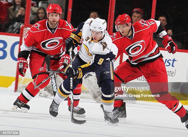 Derek Roy of the Buffalo Sabres skates for position on the ice ahead of Tim Gleason and Aaron Ward during a NHL game on February 11, 2010 at RBC...