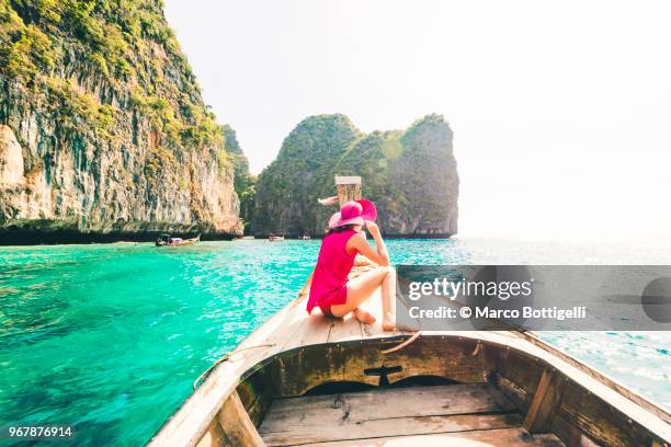 beautiful woman sitting on longtail boat at phi phi islands. - andamanensee stock-fotos und bilder