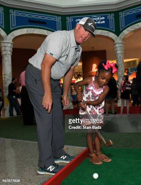 Points plays putt-putt with a young patient from St. Jude Children's Hospital during Golf-A-Round prior to the FedEx St. Jude Classic at TPC...