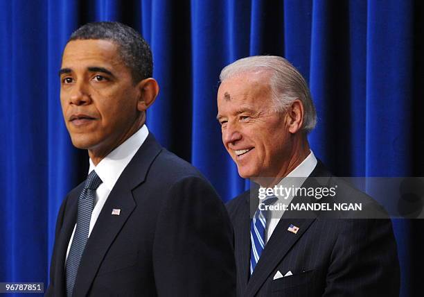 Vice President Joe Biden smiles as US President Barack Obama speaks on the economy on the first anniversary of signing the Recovery Act on February...