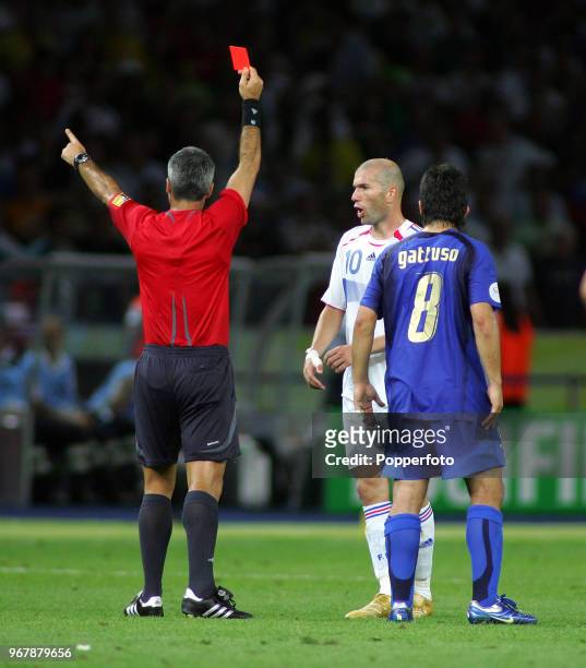 Zinedine Zidane of France is shown the Red Card by referee Horacio Elizondo for head butting an opponent, watched by Gennaro Gattuso of Italy ,...