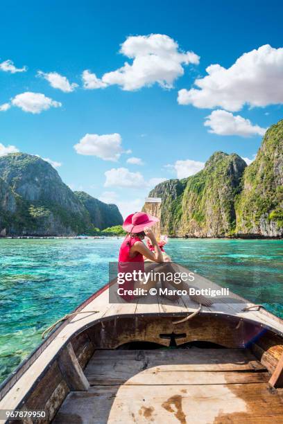 beautiful woman sitting on longtail boat at maya bay, phi phi islands. - krabi stock pictures, royalty-free photos & images