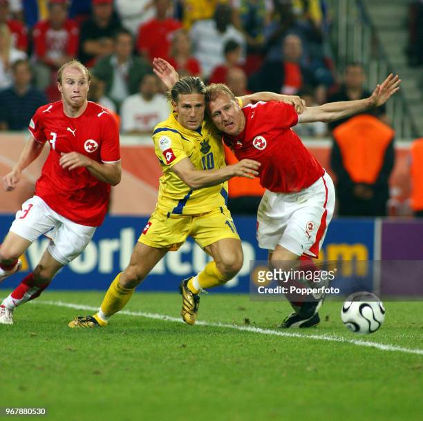 Andriy Voronin of Ukraine and Stephane Grichting of Switzerland in action during the FIFA World Cup Round of Sixteen match between Switzerland and...