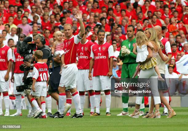 Dennis Bergkamp of Arsenal and his family wave to the fans prior to kickoff during the Dennis Bergkamp testimonial match between Arsenal and Ajax at...