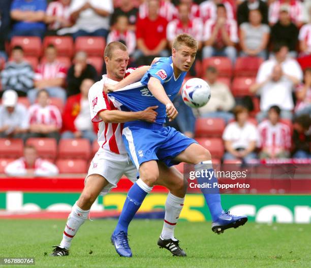 Clint Hill of Stoke City and Nicklas Bendtner of Birmingham City in action during the Championship match between Stoke City and Birmingham City at...