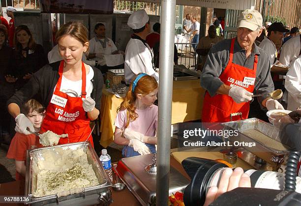 Actor Harrison Ford and actress Calista Flockhart with son Liam participate in serving Thanksgiving dinner to the Skid Row homeless at the Los...