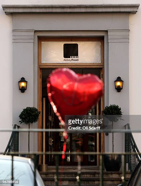 Red, heart-shaped balloon flies from railings in front of the Abbey Road recording studios, which have been put up for sale by their owner EMI on...