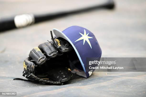 The Tampa Bay Rays cap and glove on the field before a baseball game against the Washington Nationals at Nationals Park on June 5, 2018 in...