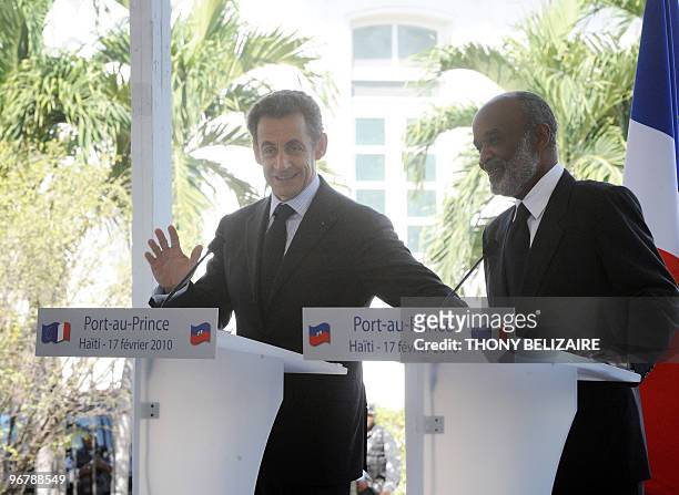 French President Nicolas Sarkozy and Haitian President Rene Preval smile during a joint press conference on the grounds of the Presidential Palace in...