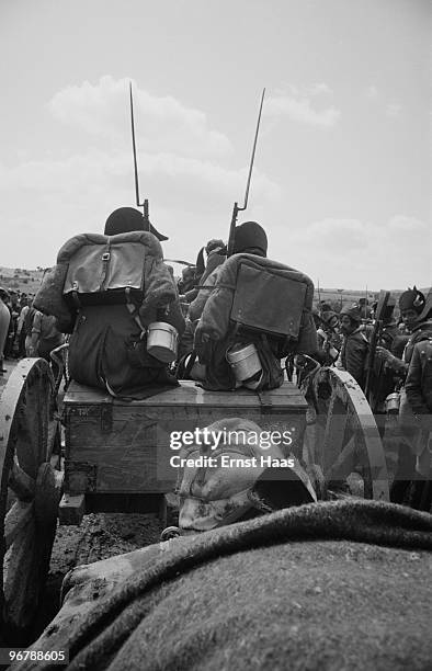 Production still showing a wounded French soldier being carted away during location filming in Spain for 'The Pride and the Passion', directed by...