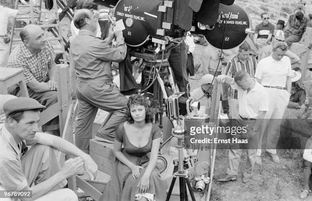 Sophia Loren on set during location filming in Spain for 'The Pride and the Passion', 1956. Among the group are cinematographer Franz Planer and...