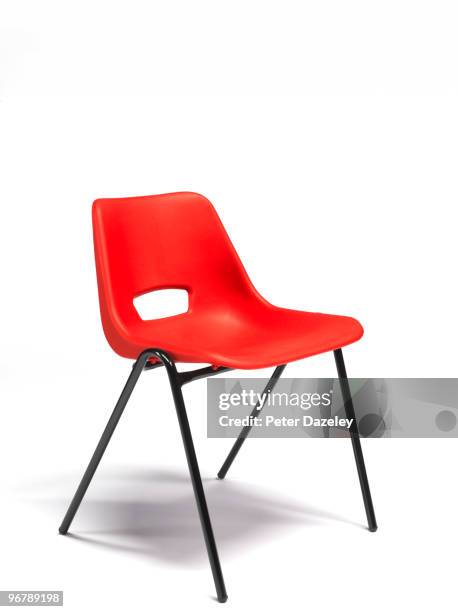 red plastic stacking chair with copy space - chair stock pictures, royalty-free photos & images