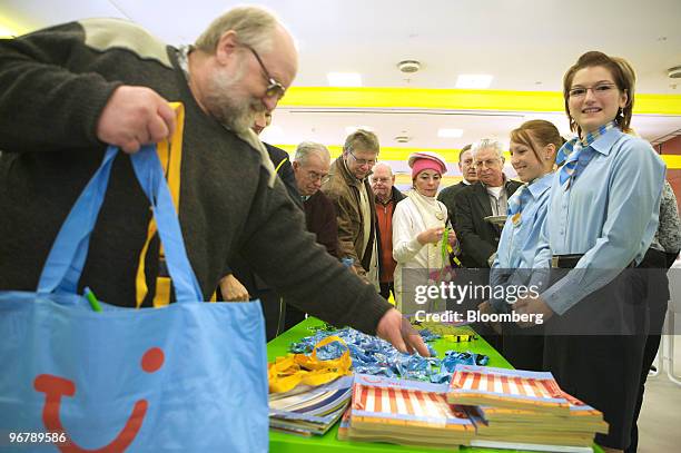 Logo is seen on a TUI AG shareholder's bag as he takes a piece of TUI-branded candy during the company's annual shareholders' meeting in Hannover,...