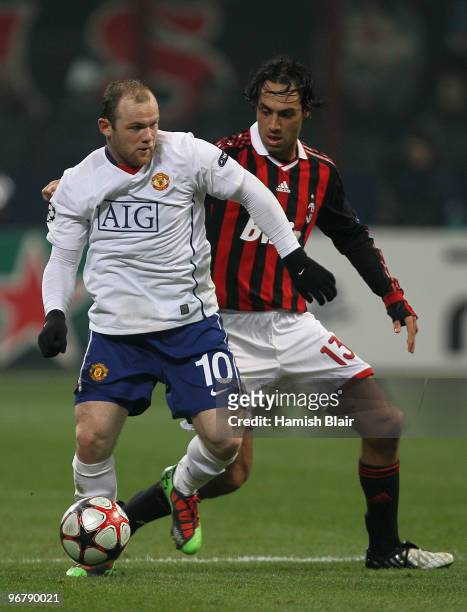 Wayne Rooney of Manchester United contests with Alessandro Nesta of AC Milan during the UEFA Champions League round of 16 first leg match between AC...