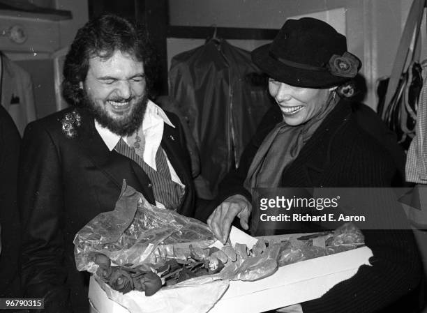 Dr John presents Joni Mitchell with flowers backstage in New York in 1977