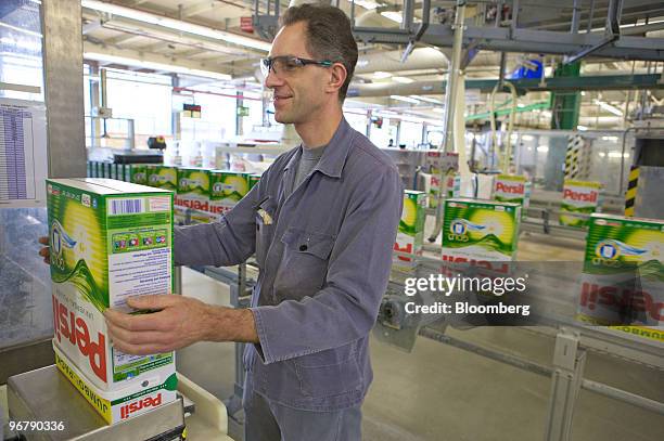 Employee Uwe Rilke checks the weight of Persil washing powder boxes inside a Henkel factory in Duesseldorf, Germany, on Tuesday, Feb. 16, 2010. The...