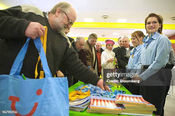 Logo is seen on a TUI AG shareholder's bag as he takes a piece of TUI-branded candy during the company's annual shareholders' meeting in Hannover,...