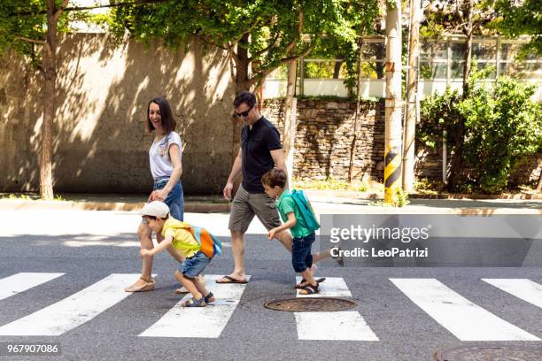 family crossing the street...having fun - south korea people stock pictures, royalty-free photos & images