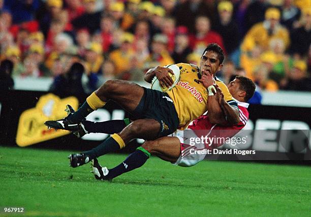 Andrew Walker of Australia is hauled down by Lions'' Jason Robinson during the Third Tom Richards Cup Match between British Lions and the Australian...