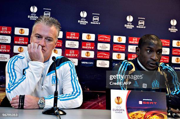 French team Olympique de Marseille's head coach Didier Deschamps and his team's captain Mamadou Niang listen to journalists' questions on February 17...